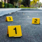 Modena Carnage: Knife-Wielding Driver’s Shocking Rampage Crime scene markers on asphalt with bullet casing.
