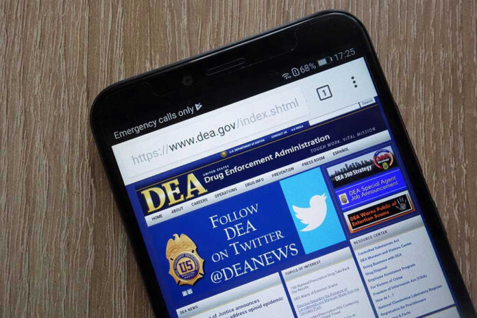 1134657176 DEA website open on smartphone screen.