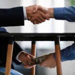 City Hall Bribery Bombshell Handshake and exchange of money under the table.