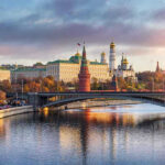 Putin’s ‘Peace’ Demands Surrender Kremlin by river at sunset with bridge.