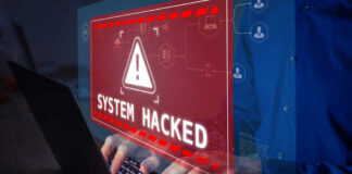 Warning sign System Hacked on laptop screen.