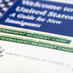 Permanent resident cards with welcome guide and flag.