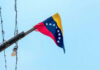 Shock Strike Inside Venezuela Venezuelan flag flying on a pole.