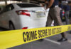Gas Station Ambush Leaves One Shocking Question Crime scene tape blocking off white sedan.