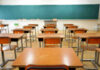Child Meals Scam — Fugitive Nabbed Abroad Empty classroom with desks and a chalkboard.
