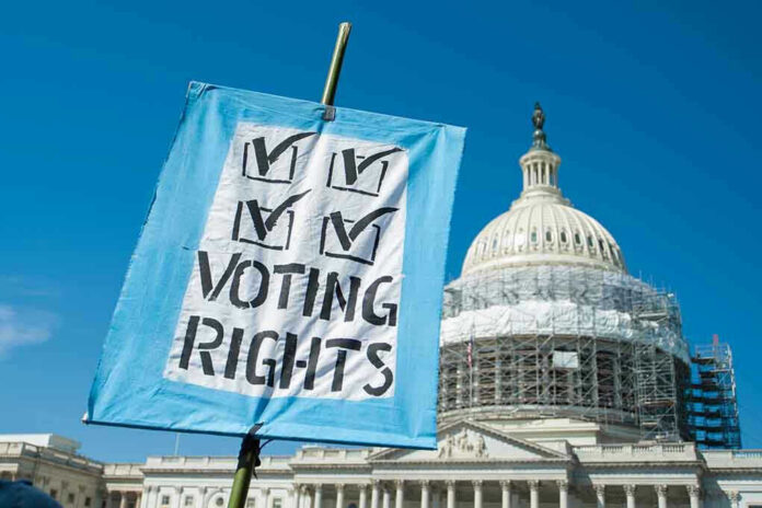 Sign reading Voting Rights in front of Capitol building.