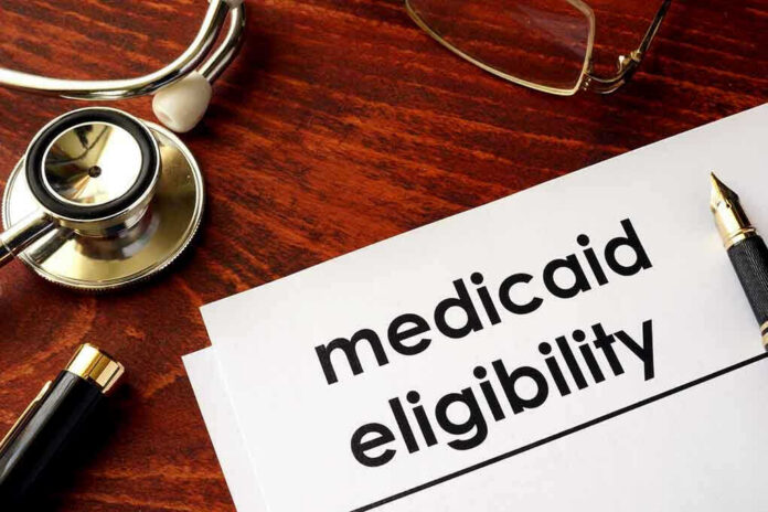 640488934-1 Stethoscope pen document about Medicaid eligibility on table