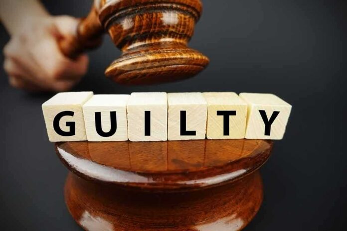 shutterstock_1014820045 A gavel striking down next to wooden blocks spelling 'GUILTY'