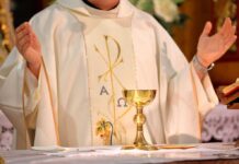 FBI Fires Catholic Memo Crew A priest holding a golden chalice during a religious ceremony