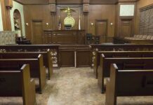 Clemency Whiplash Shocks Colorado Interior view of an empty courtroom with wooden benches and a judges bench