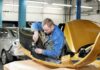 Mechanic working on a car part in a workshop