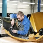 Trump Calls Out Car Repair Blockade Mechanic working on a car part in a workshop
