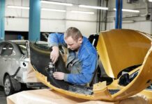 Mechanic working on a car part in a workshop
