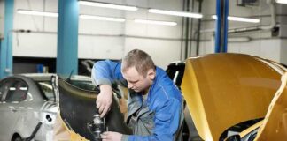 Mechanic working on a car part in a workshop