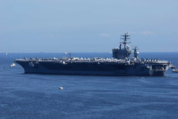 shutterstock_1340097212 A large aircraft carrier sailing in the ocean
