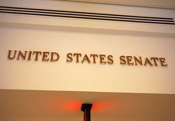 A,Sign,Marks,An,Entrance,To,The,United,States,Senate Sign displaying United States Senate in a government building
