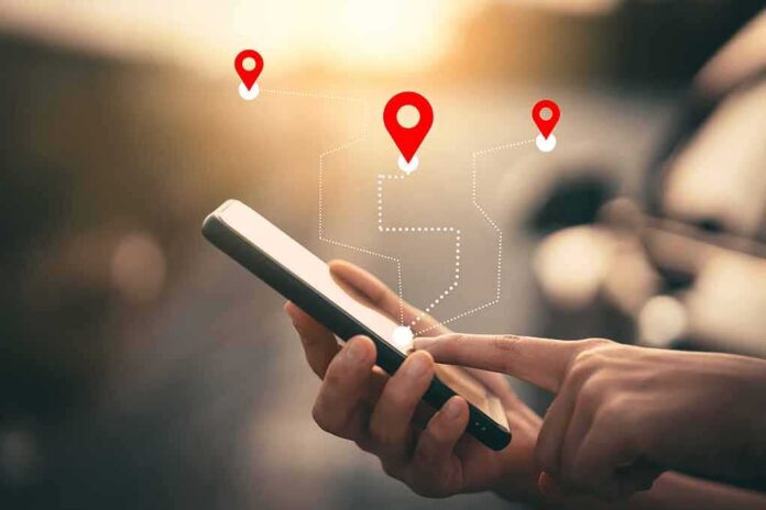 Person using a smartphone with location markers displayed on the screen