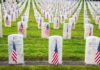 18 Veterans A Day—Congress’ Gut-Check Moment Rows of grave markers adorned with American flags in a military cemetery