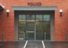 Police Chief Indicted: 70 Shocking Counts Entrance of a modern police station with brick facade