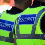 Porta-Potty Horror Stuns Electric Forest Two security personnel wearing high visibility vests with SECURITY printed on the back