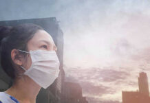 Air Turns Hazardous In Toronto Person wearing a mask in a cityscape background.