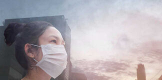 Person wearing a mask in a cityscape background.