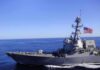 Gulf Powder Keg: Who Actually Hit Those Tankers? Naval destroyer sailing on open sea with flag flying