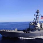 Gulf Powder Keg: Who Actually Hit Those Tankers? Naval destroyer sailing on open sea with flag flying