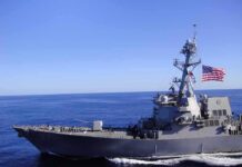 Gulf Powder Keg: Who Actually Hit Those Tankers? Naval destroyer sailing on open sea with flag flying