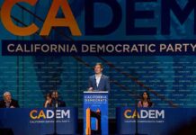 Democrats Borrow Trump—Blue MAGA? Speaker at podium during California Democratic Party event
