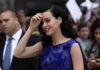 Pop Star Outrage — White House Doubles Down woman in a blue dress smiling at an outdoor event