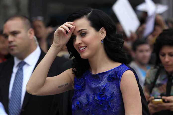 woman in a blue dress smiling at an outdoor event