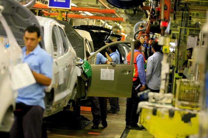 auto assembly line with workers installing car doors