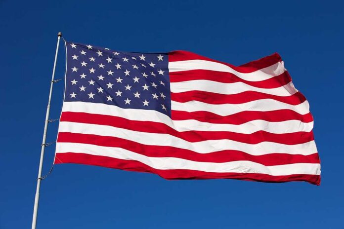Waving American flag against a clear blue sky