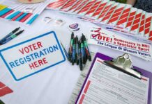 Homeless Exploited, Power Players Glide Voter registration table with forms, pens, and informational materials