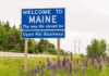 Welcome to Maine roadside sign with wildflowers