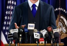 July 4 JOLT: Trump Rings Putin, Zelenskyy A speaker at a press conference with multiple microphones in front of them