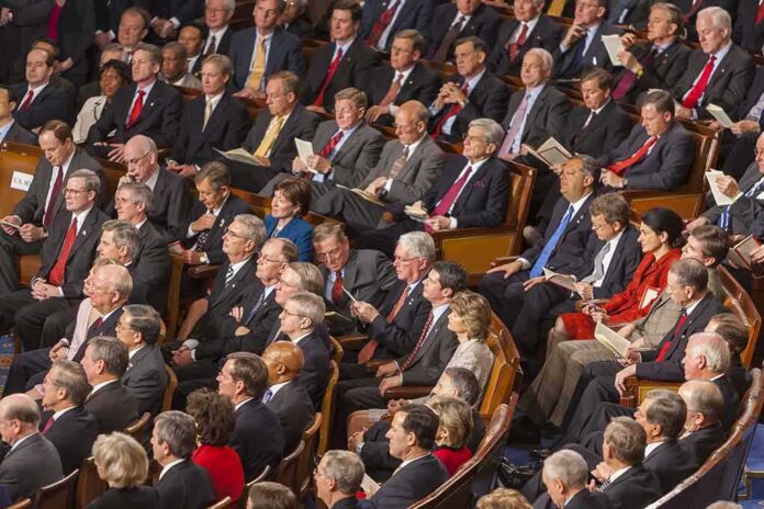 shutterstock_492045043 Audience of formally dressed people seated in a large auditorium