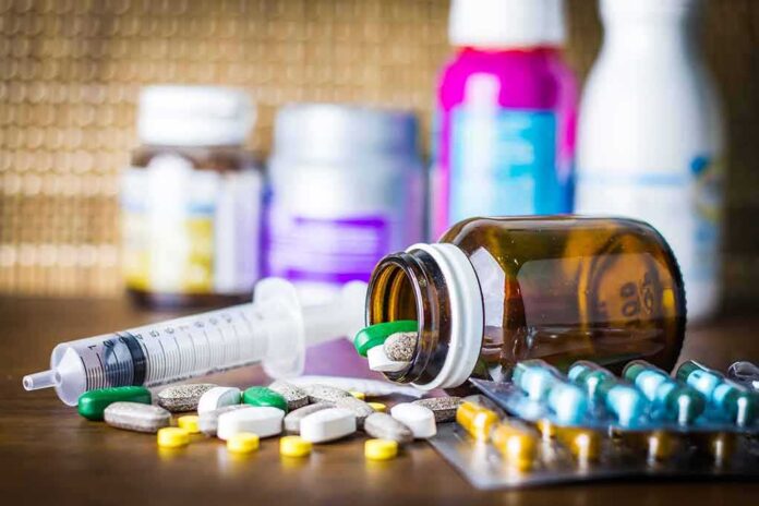 shutterstock_544348294-1 Medicine pills and syringe on table with brown bottle
