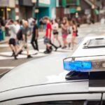 Parents Panic As Accused Threat Maker Freed Police car lightbar with blue light near a busy crosswalk