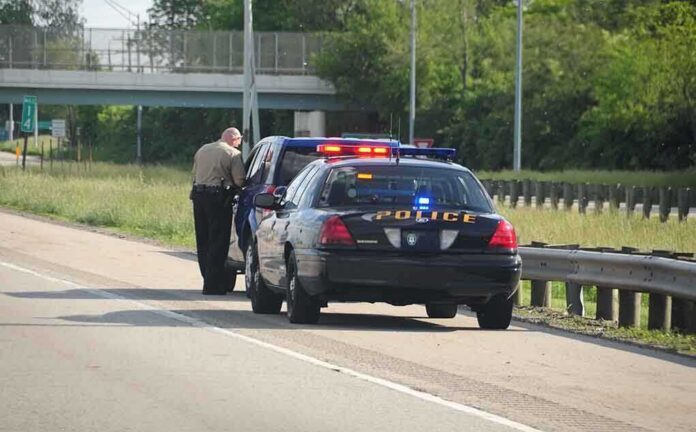 shutterstock_12763549 Police officer conducting a traffic stop on a highway