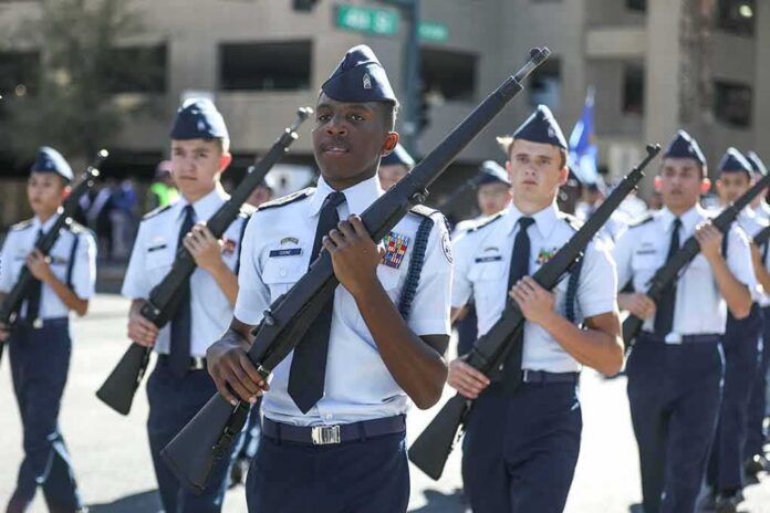 shutterstock_1559051852 cadets marching in formation with rifles