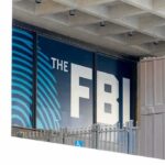 Judge-Backed Warrants Hit Swalwell FBI sign on building facade behind metal fence