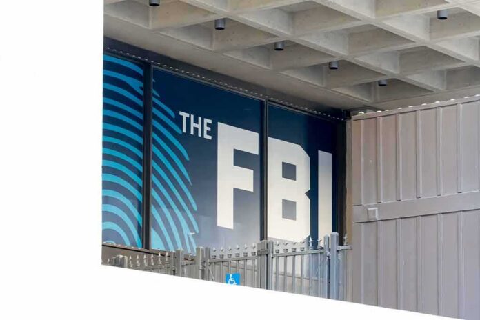FBI sign on building facade behind metal fence