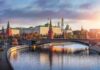Kremlin complex by a river at sunset