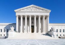 Pandemic Cash Grab: State Rep Indicted The Supreme Court building featuring marble columns and a clear blue sky