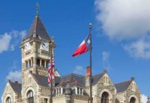 Foreign Porn Site Frozen — Bond Sky-High Historic stone courthouse with clock tower and flags