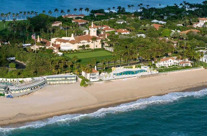 shutterstock_617489111 Aerial view of a beachfront estate with pool and palm trees