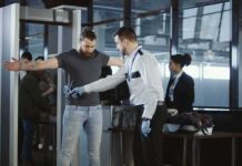 TSA Rule Turns Snacks Into Contraband Airport security officer scanning a passenger with a handheld metal detector