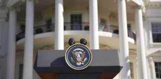 Presidential podium with seal in front of white-columned building